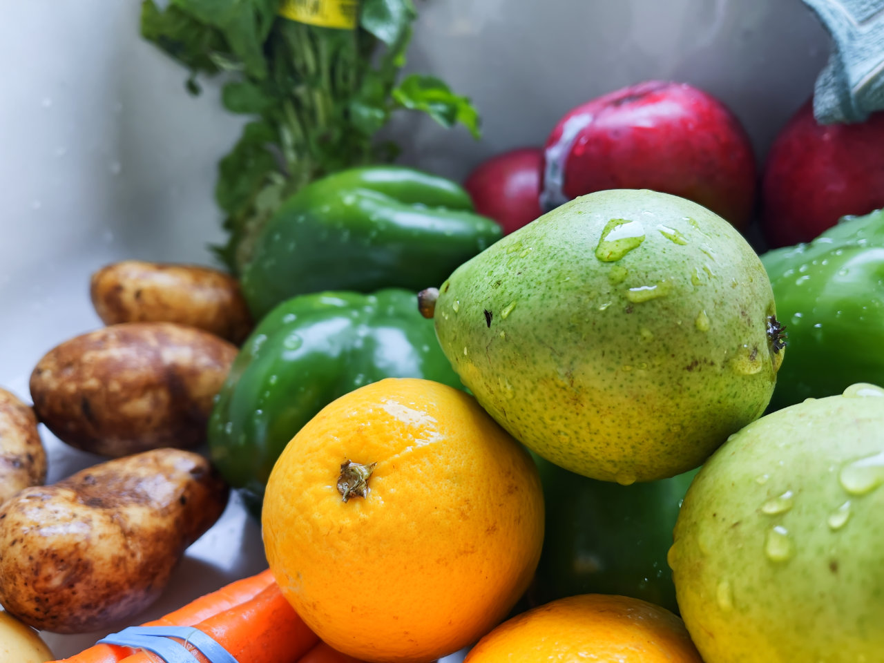 Freshly washed fruits and vegetables in the kitchen sink