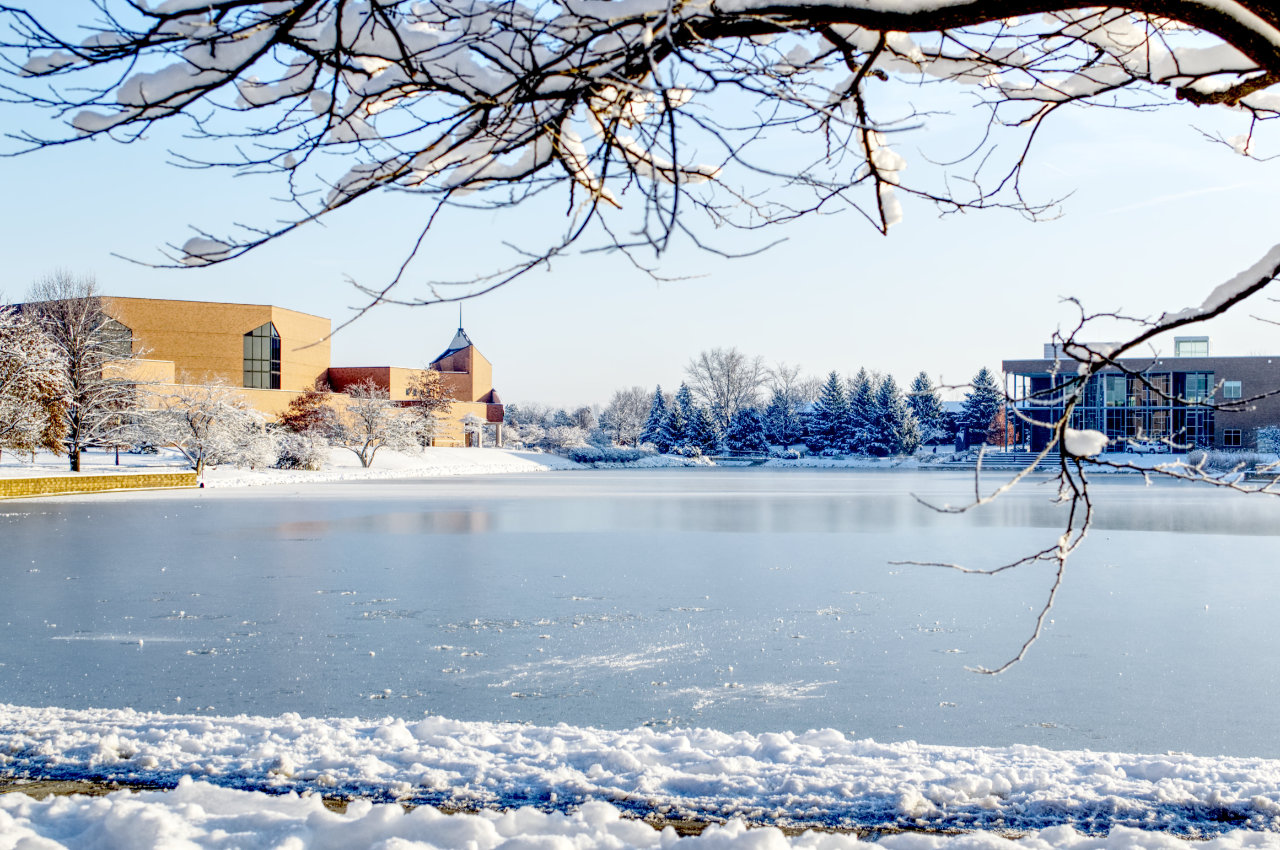 Chapel across a frozen lake surrounded by snow
