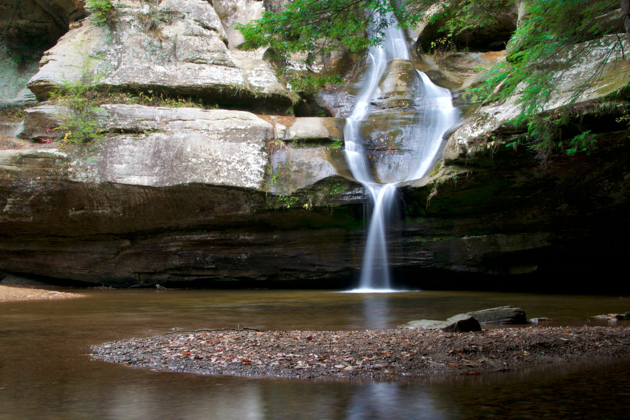Waterfall flowing gracefully into a calm river